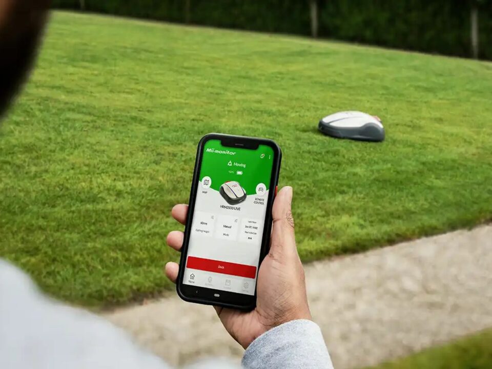 User controlling a robotic lawn mower with a smartphone app.
